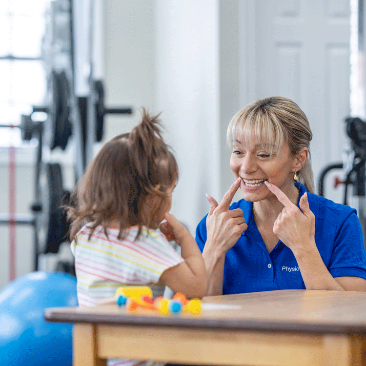 Speech therapist conducting exercises with a young girl.