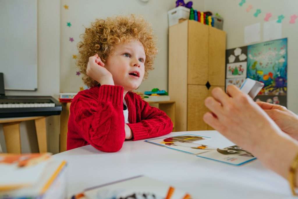 Young boy in a speech therapy session. Symbolizing early intervention of speech delay and autism.