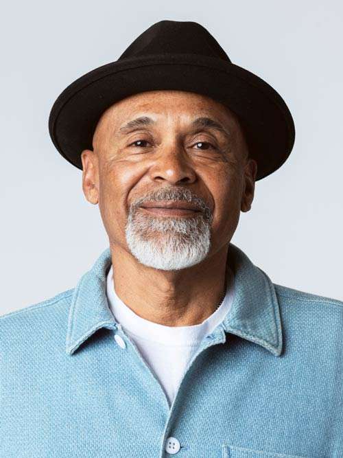 An older man with a hat slightly smiling. Happy with his speech therapy.