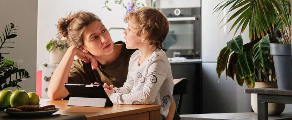 Child and mother at home, engaging in speech therapy exercises.
