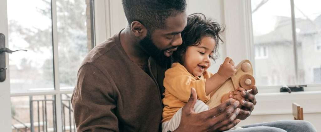Toddler with dad at home, representing a child with articulation disorder.