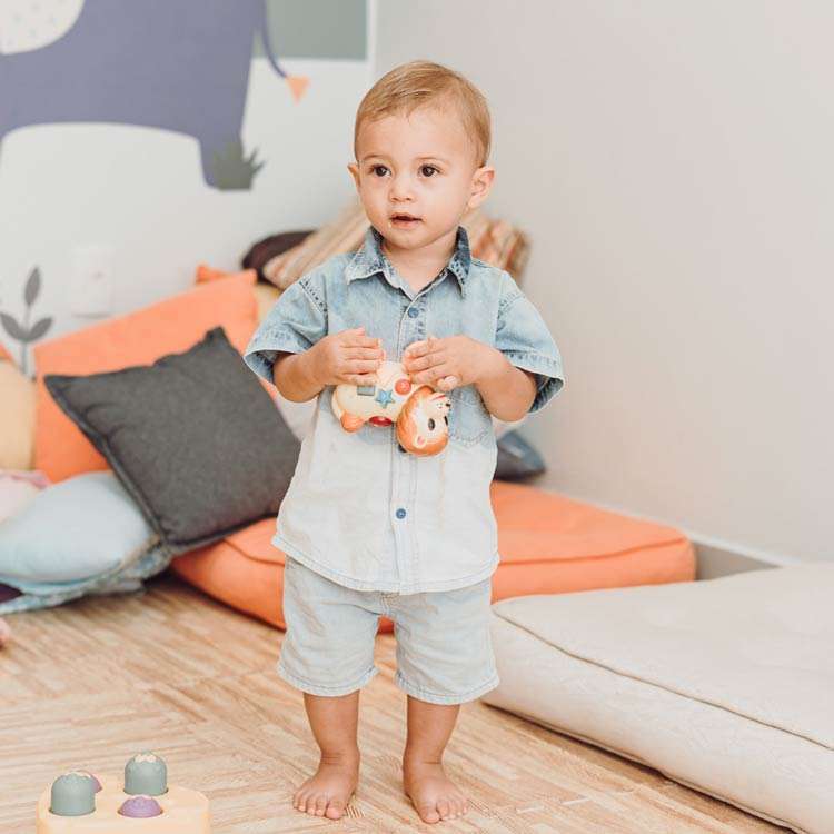 Full-body image of a toddler at home, illustrating when to seek help for speech disorders.